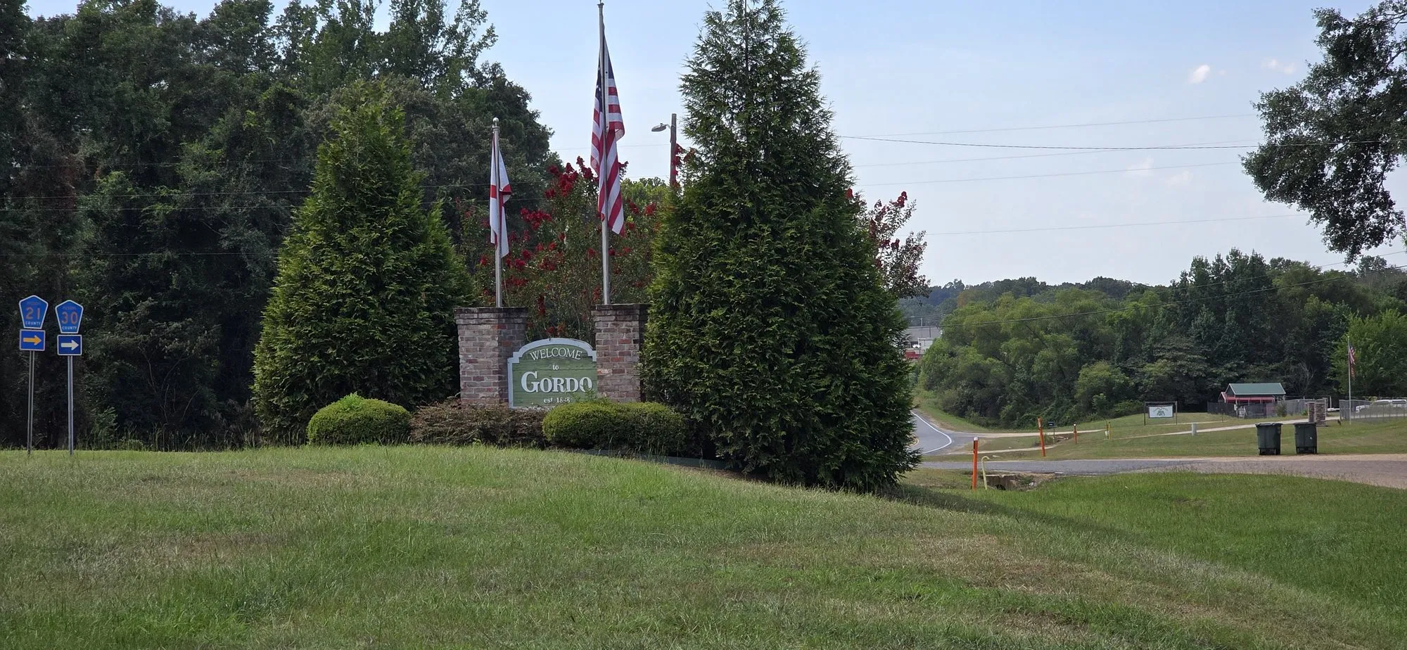 Welcome sign and flags at the entrance to Gordo