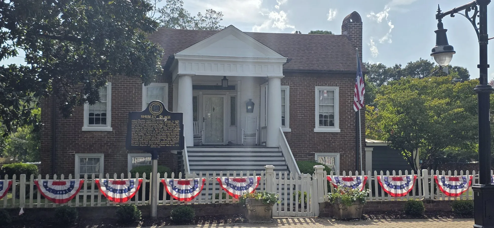 Historic brick building with bunting in downtown Northport